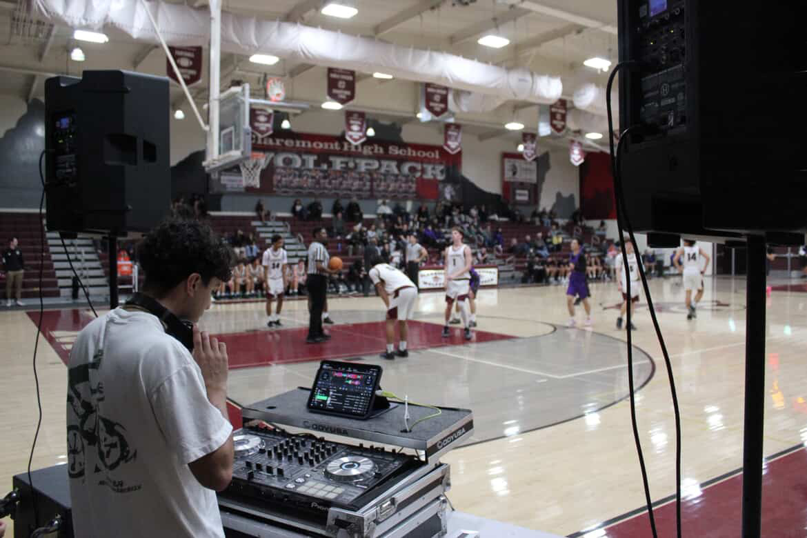 DJ Balcázar working the decks courtside at a Claremont High School basketball game.